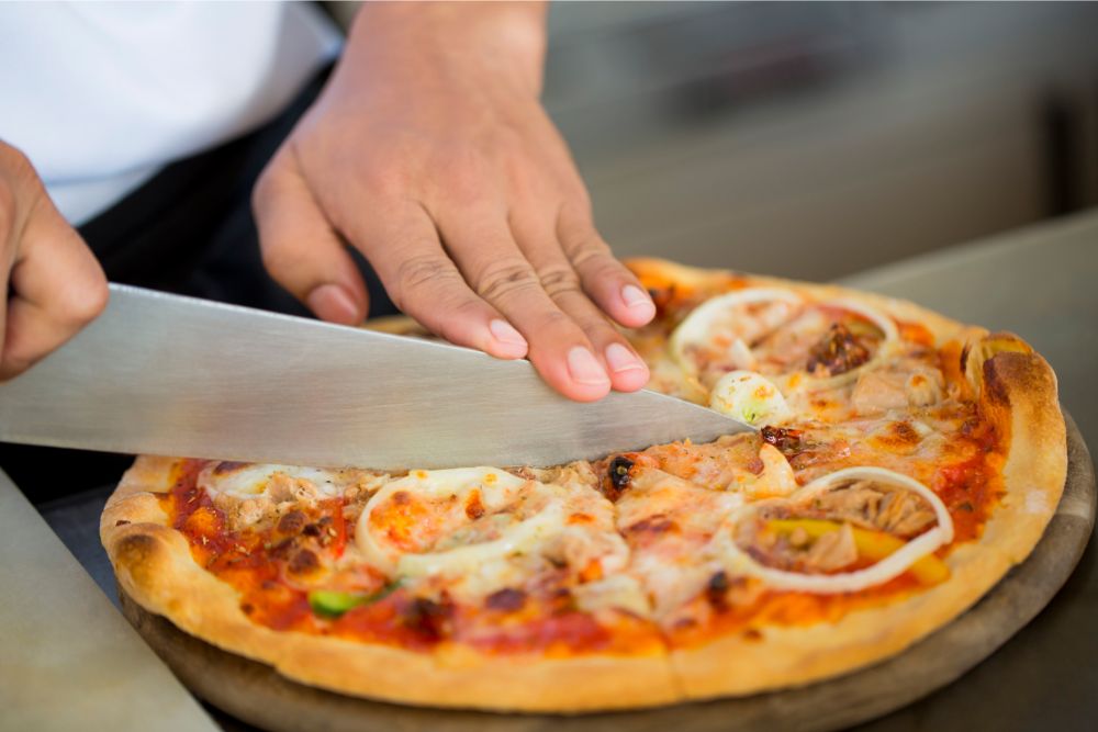 cutting pizza with knife